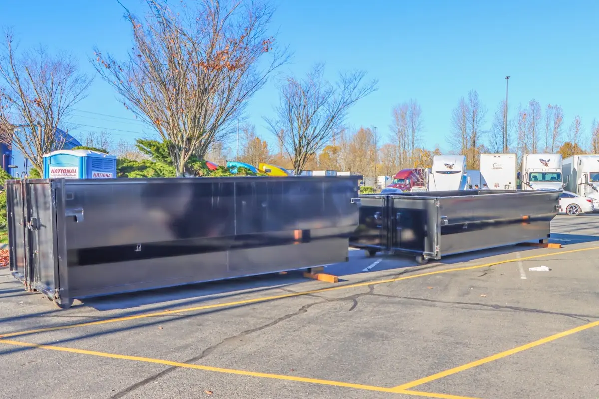 Professional dumpster rental service with roll-off container on residential driveway in Bell Gardens